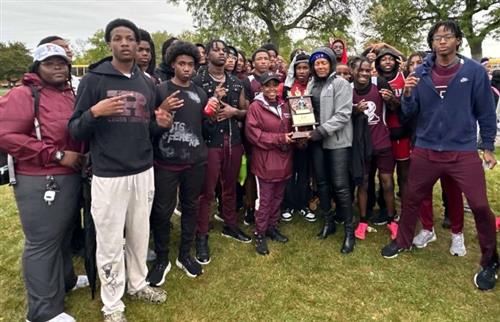 Boys Cross Country Team posing with coach and trophy